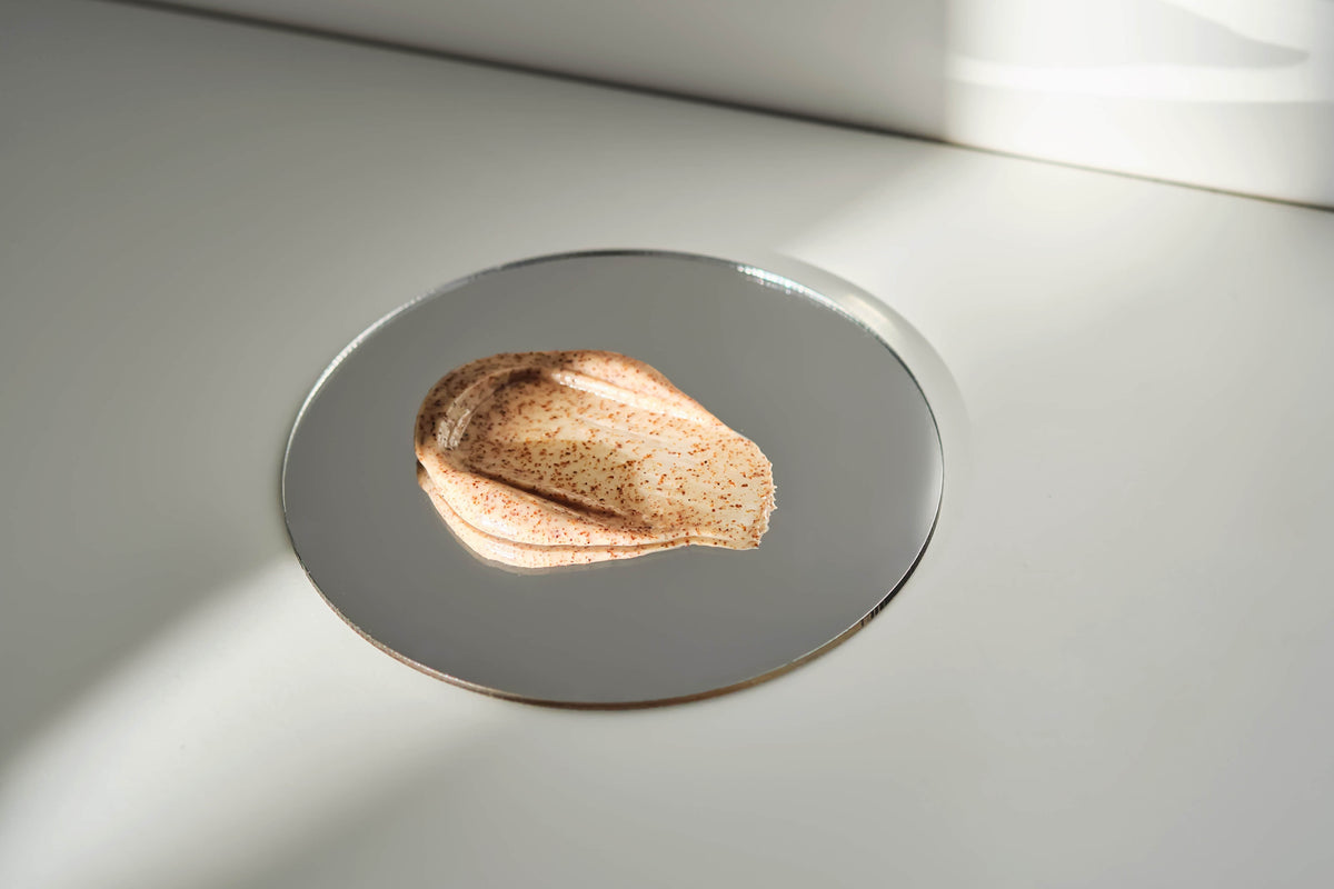 Metallic object on a reflective surface with a light source casting shadows