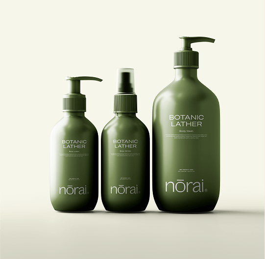 Three green bottles of norai Botanic Lather on a beige background