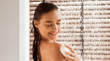 Woman showering with a white showerhead