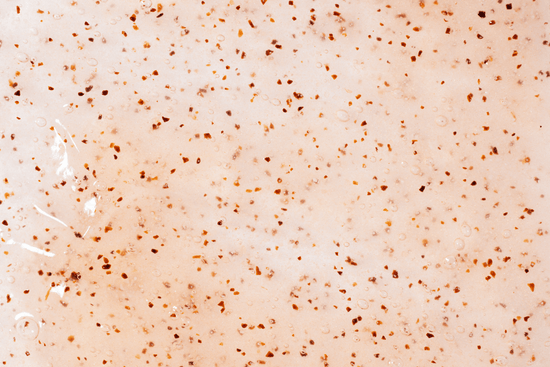 Close-up of a textured surface with small brown specks