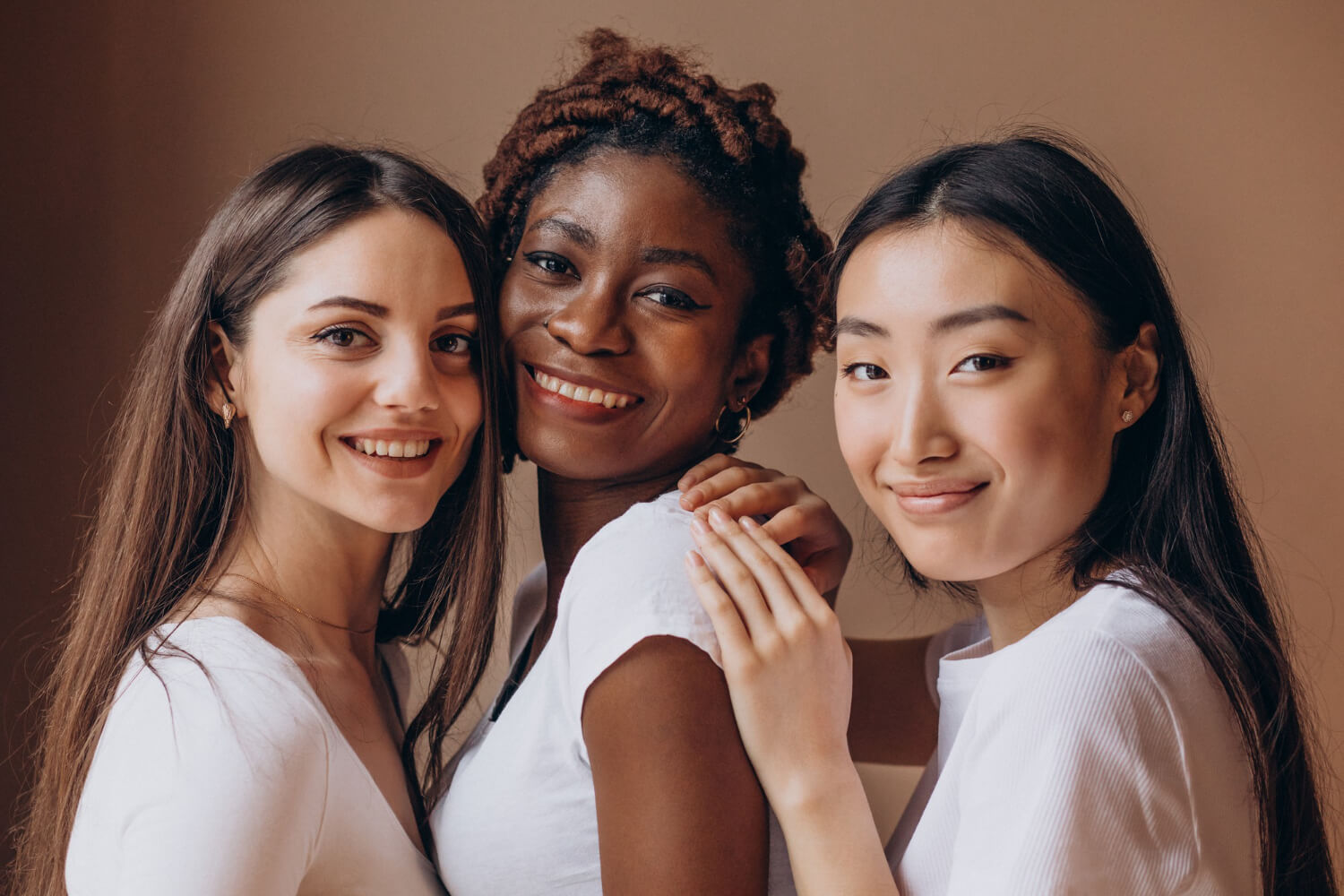 Three women with a gray background