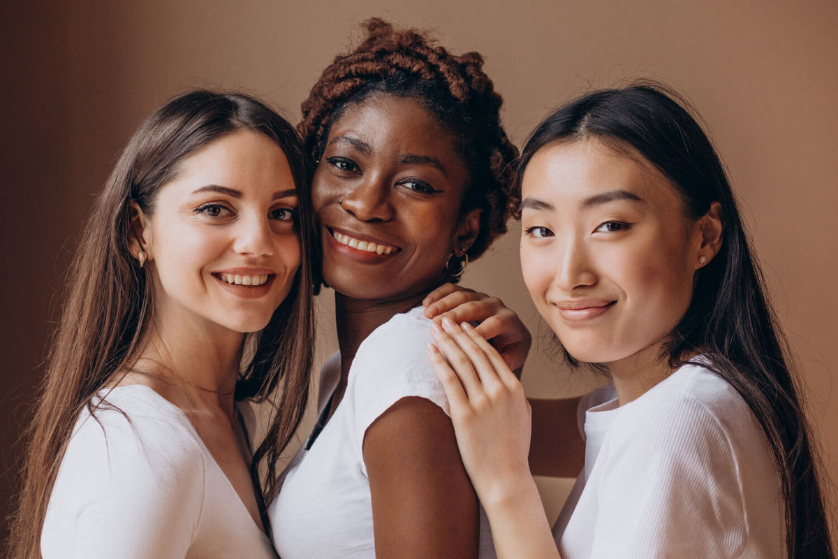 Three women with a gray background