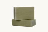 Two stacked green soap bars on a white background