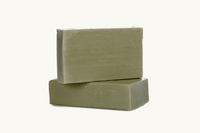 Two stacked green soap bars on a white background