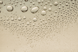 Close-up of water droplets on a beige surface