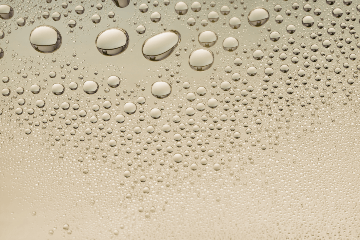 Close-up of water droplets on a beige surface