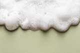 Foamy soapuds on a light green background